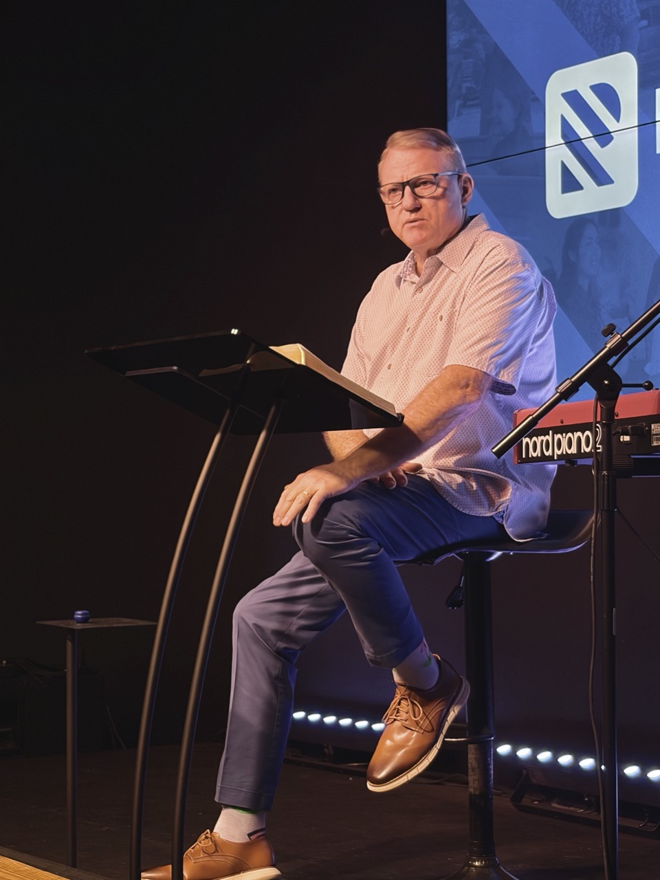 Pastor preaching from a stage